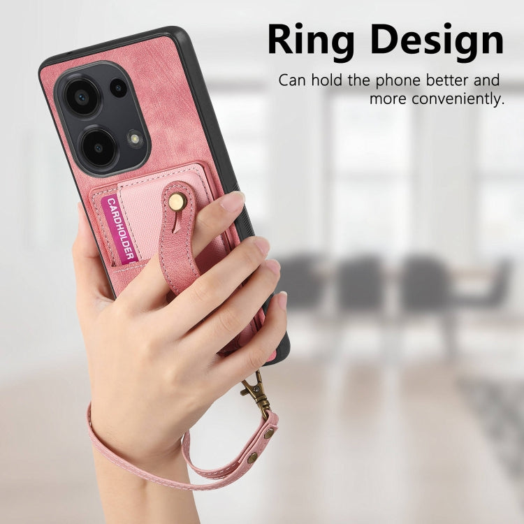 Pink leather wallet phone case with wrist strap and card slots held in a hand