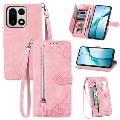 Pink leather phone case with embossed floral pattern, front zipper, and wrist strap