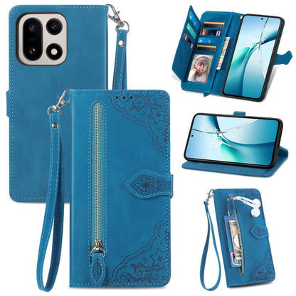 Blue leather wallet phone case with embossed floral pattern, zipper pocket, and strap