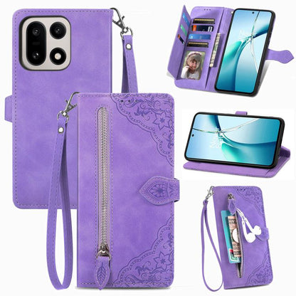 Purple leather phone case with embossed floral pattern, front zipper, and wrist strap