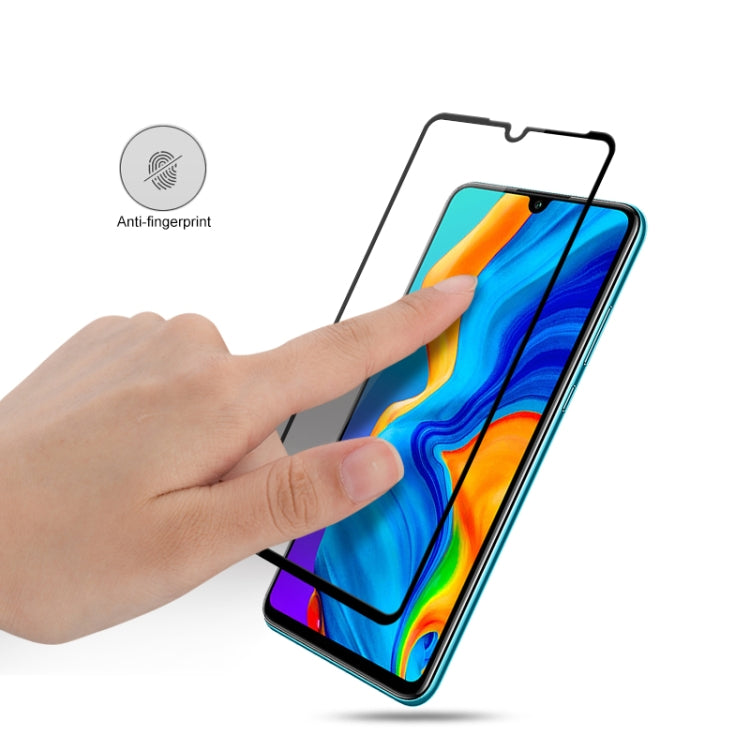 Tempered glass screen protector film being applied to smartphone screen with anti-fingerprint