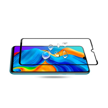 Tempered glass screen protector film aligned on smartphone display with install frame