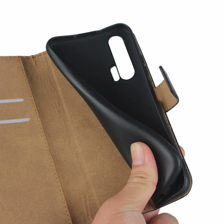 Black leather flip phone holster wallet with tan card slots and flip cover