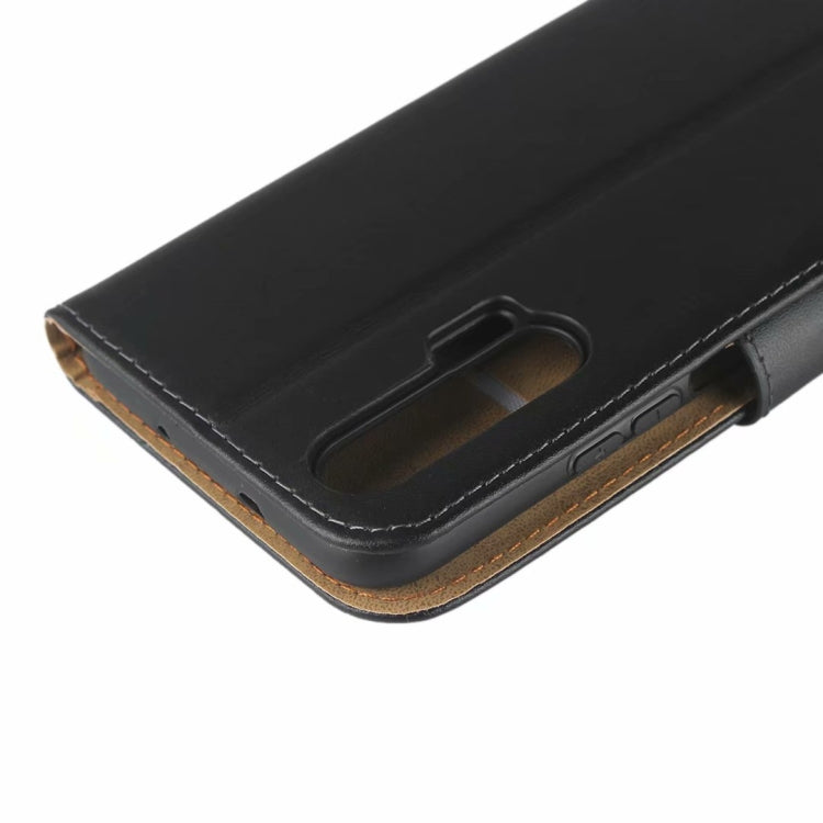 Close-up: black leather flip holster corner with card/slot opening and stitching
