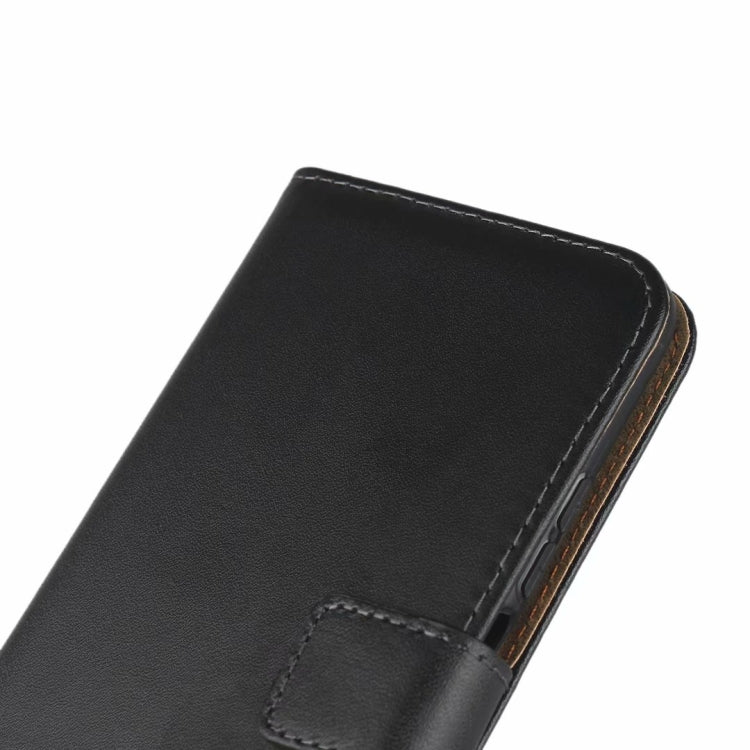Close-up: black leather folio edge with stitched panel and back strap
