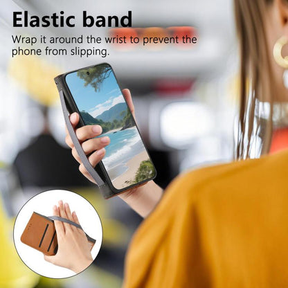Brown leather phone case with elastic wrist band to help prevent slipping.