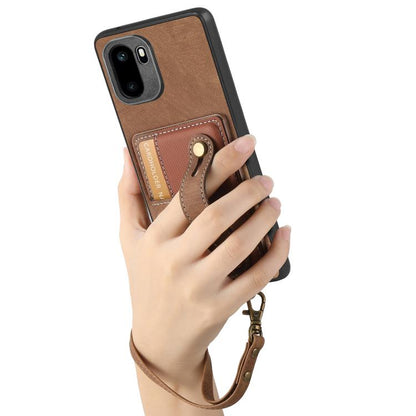 Brown leather phone wallet case with wrist strap held in hand