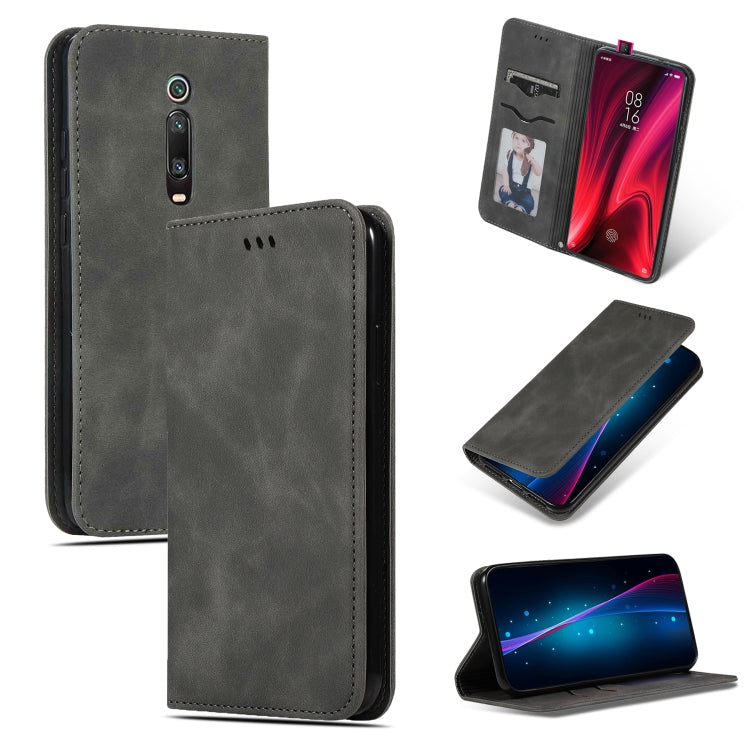 Dark gray magnetic flip wallet phone case with stitched edges and camera cutout.