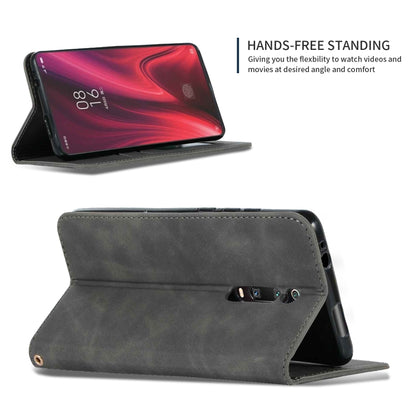 Dark gray folio wallet phone case standing in landscape with flip cover folded back.