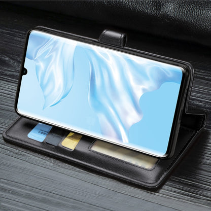 Black leather wallet phone case with front flap and card holder slots, phone inside