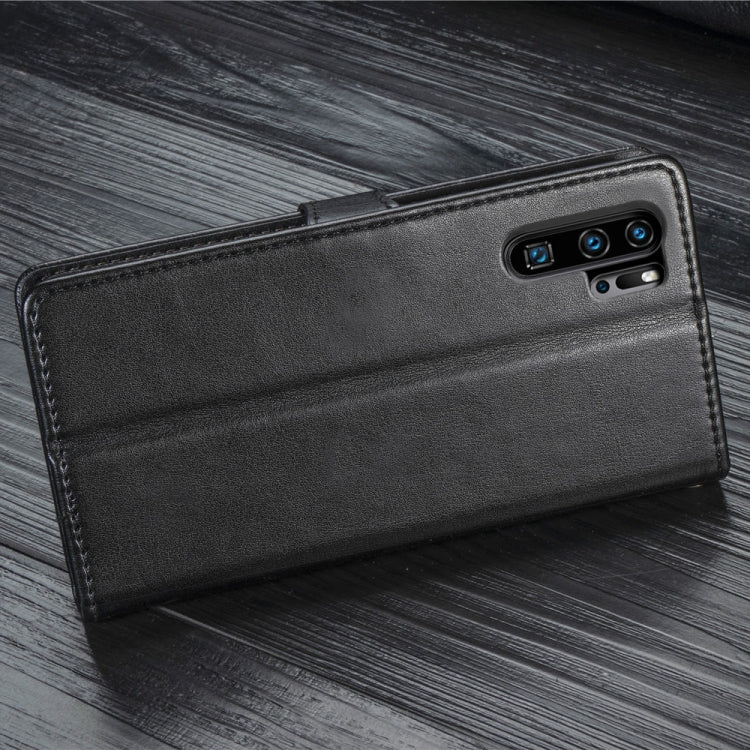 Black leather wallet phone case with camera cutouts, side angle view