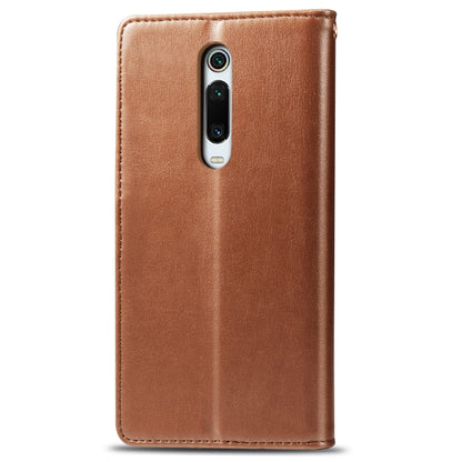 Brown leather flip phone case with camera cutout and stitched edges