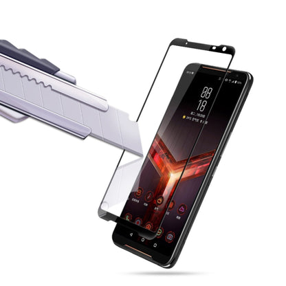 Tempered glass screen protector being aligned on Asus ROG Phone II, full coverage