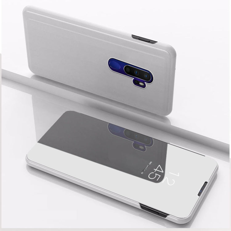 Silver flip phone case with stand, mirror-style inner panel, camera opening visible