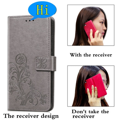 Gray leather phone wallet case with embossed floral pattern and wrist strap