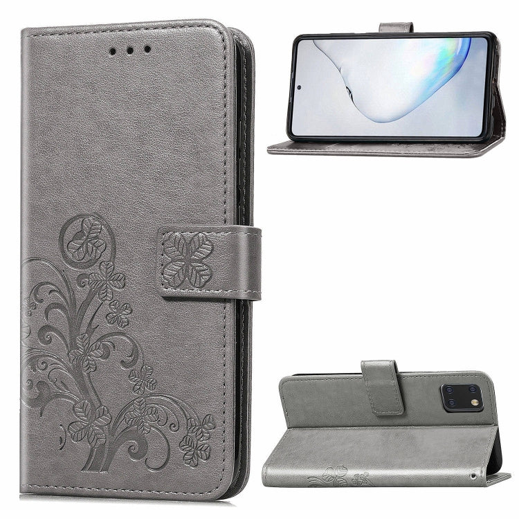 Phone folio case with pressed flower pattern, card slots, and kickstand; gray leather.