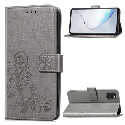 Phone folio case with pressed flower pattern, card slots, and kickstand; gray leather.