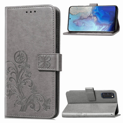 Gray phone folio wallet case with pressed flower embossing, card slots, and kickstand.