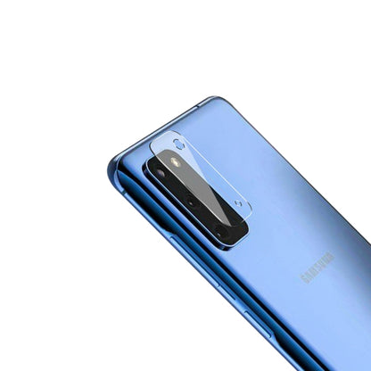 Tempered glass rear camera lens protector film on blue phone back, angled camera module
