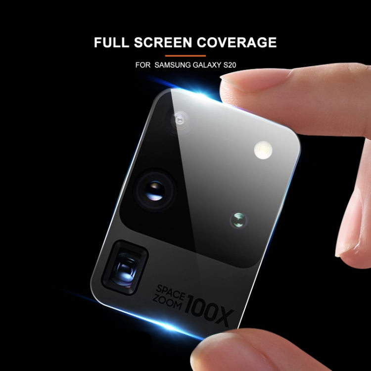 Tempered glass rear camera lens protector film on phone back, fingers applying it