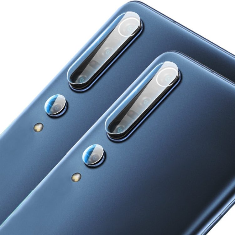 Rear camera lens protectors made of tempered glass on a blue smartphone back