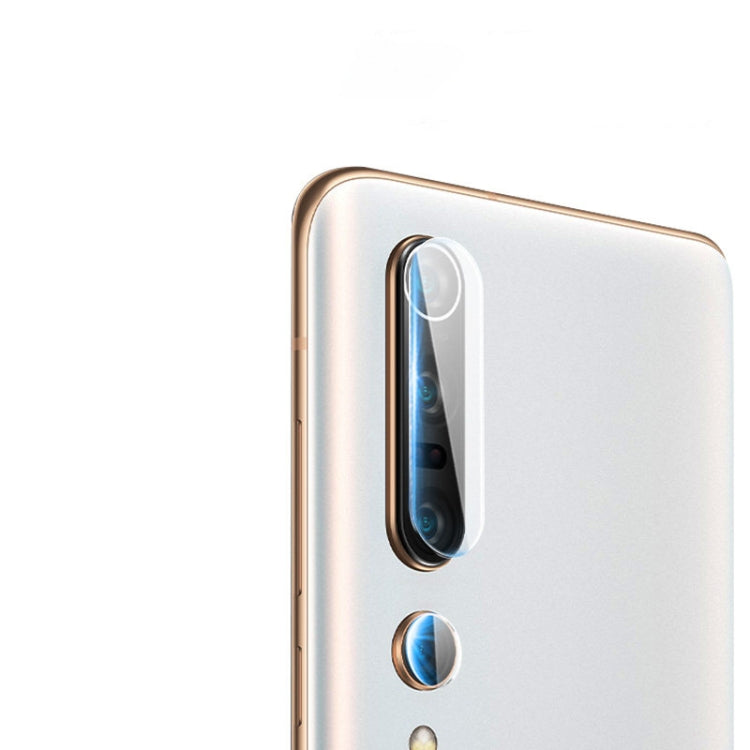 Tempered glass film covering a rear camera lens on a white smartphone back