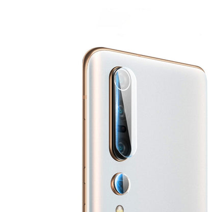 Tempered glass film covering a rear camera lens on a white smartphone back