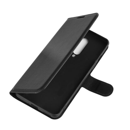 Black slim flip phone case with stand and camera cutout, angled side view