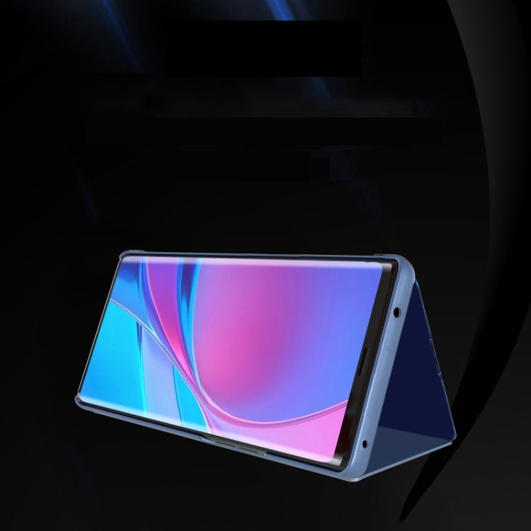 Blue mirror flip leather phone case with holder, front cover open to show display.