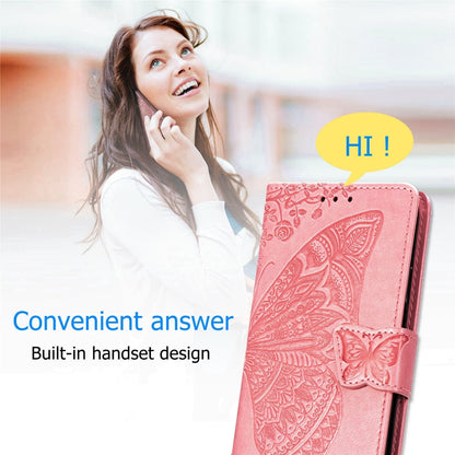 Butterfly-embossed pink flip leather phone case with wrist strap, open front