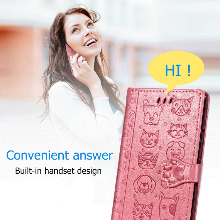 Pink flip phone case with embossed cat-and-dog pattern and fold-over wallet cover.