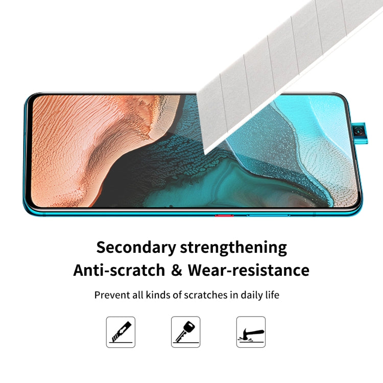 Edge-to-edge tempered glass screen protector film on a phone, side angle view