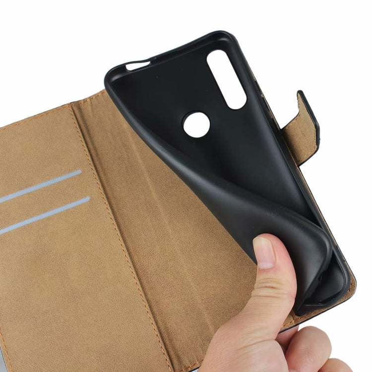 Hand inserting phone into black leather flip wallet case with card holder