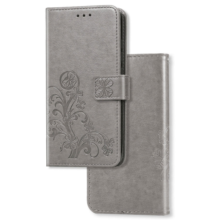 Gray leather phone wallet case with pressed clover floral pattern and card-holding flip cover