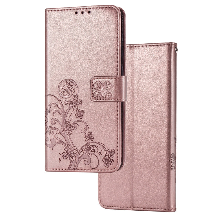 Rose-gold leather phone wallet case with pressed clover floral pattern and flip card slots