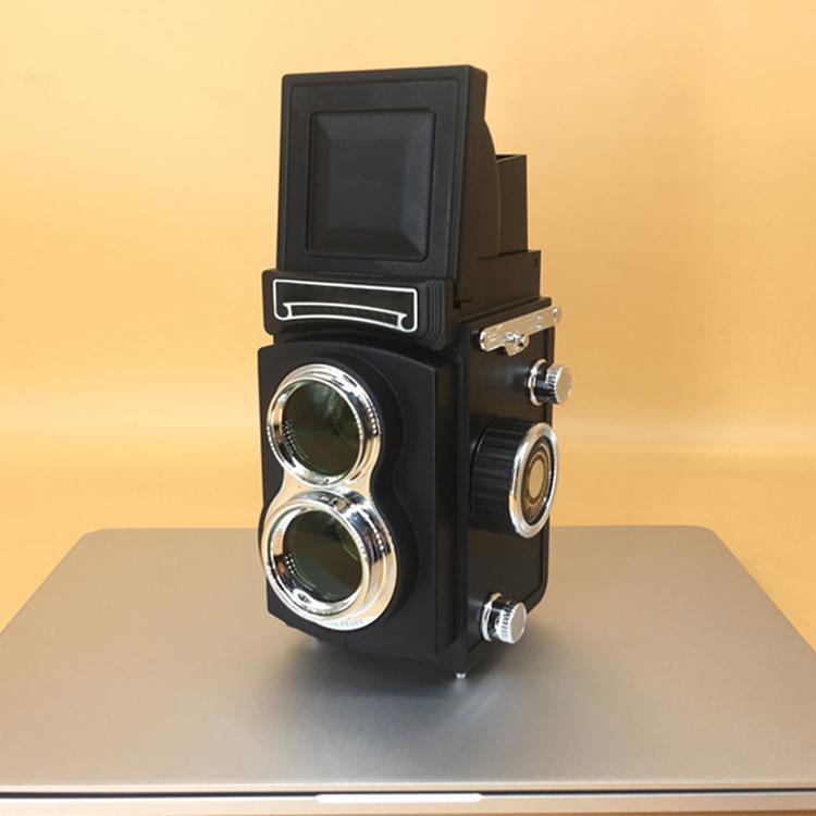 Black retro double reflex camera prop with twin lenses and viewfinder