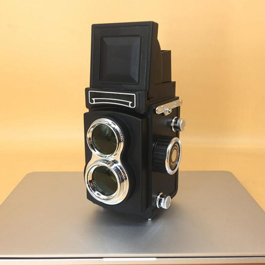 Black retro double reflex camera prop with twin lenses and viewfinder