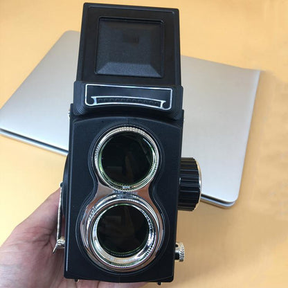 Black retro double reflex camera prop, front view with twin chrome lenses