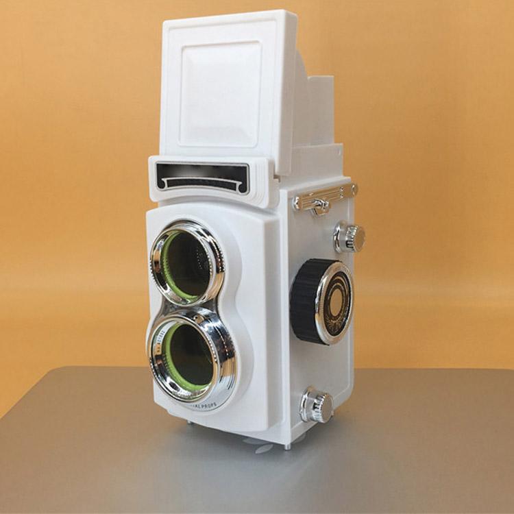 White retro double reflex camera prop with twin lenses and side knobs