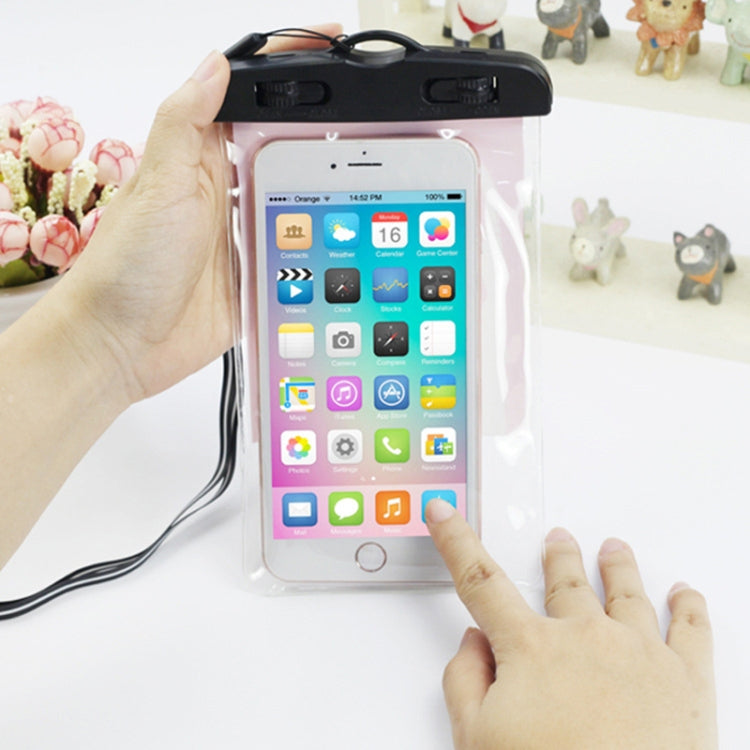 Hand holding a phone in a transparent waterproof pouch with black top and touch screen