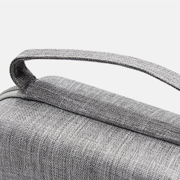 Gray fabric handle and textured top of portable cable storage bag