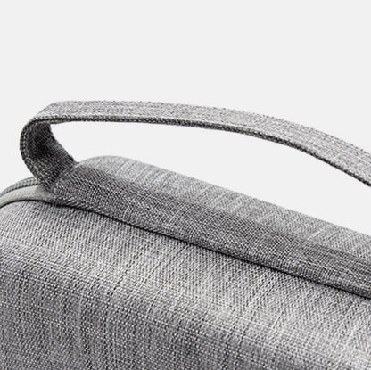 Gray fabric handle and textured top of portable cable storage bag