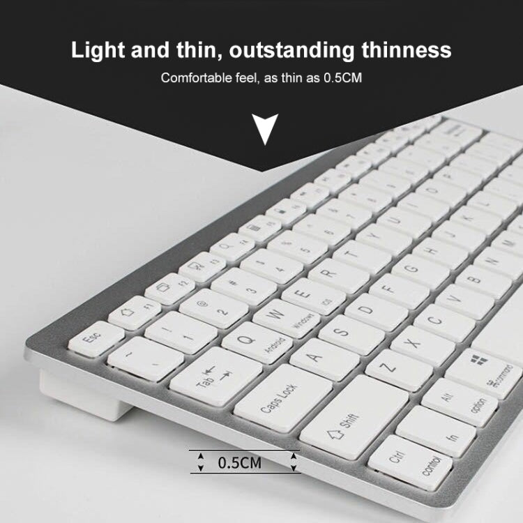 Silver mini wireless Bluetooth keyboard, close-up of white keycaps on thin frame