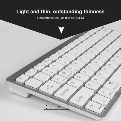 Silver mini wireless Bluetooth keyboard, close-up of white keycaps on thin frame