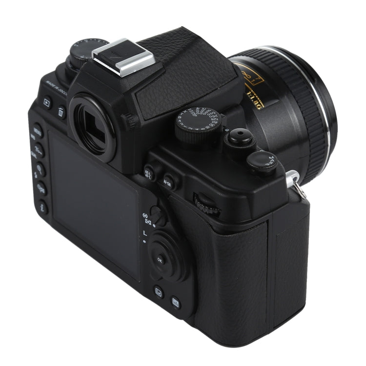 Black DSLR-style fake camera model with viewfinder and shoulder grip