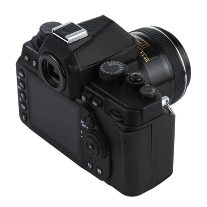 Black DSLR-style fake camera model with viewfinder and shoulder grip