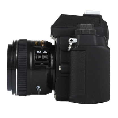 Black DSLR-style fake camera model side view with focus-style dial and lens