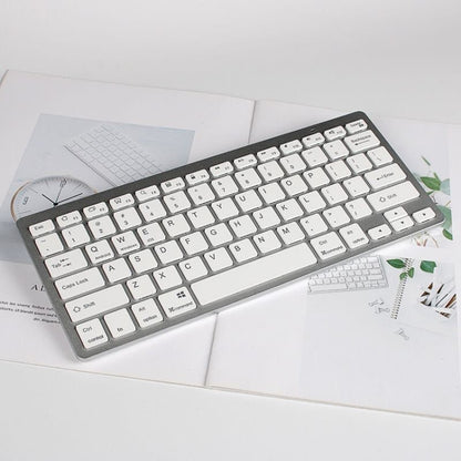 Silver mini wireless Bluetooth keyboard with white keycaps