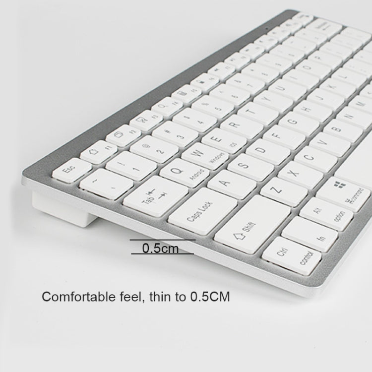 Ultra-thin mini keyboard angled view with white keycaps on dark base