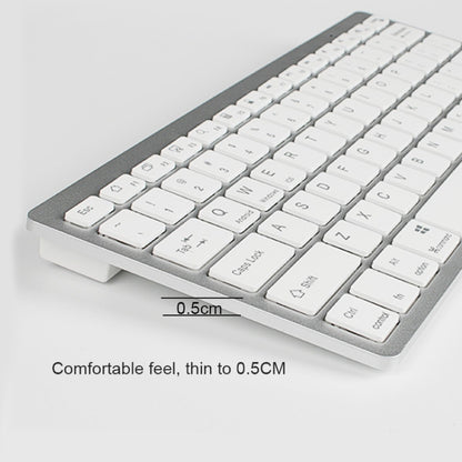Ultra-thin mini keyboard angled view with white keycaps on dark base